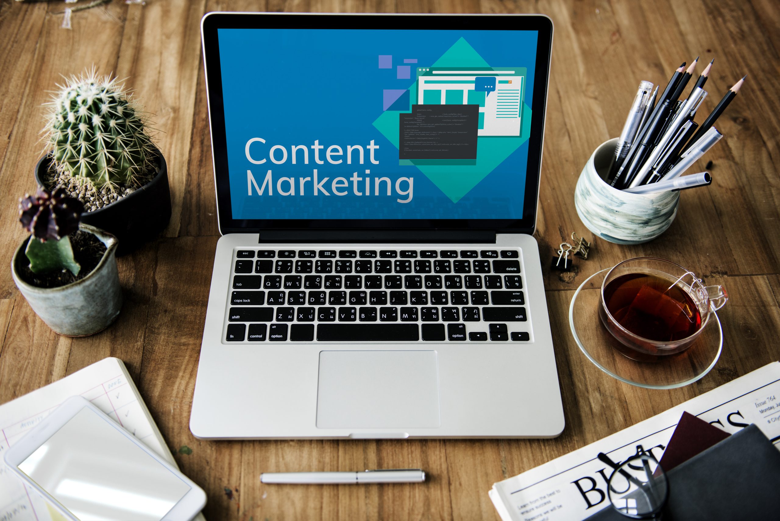 Content marketing plan shown on computer screen with wooden table background