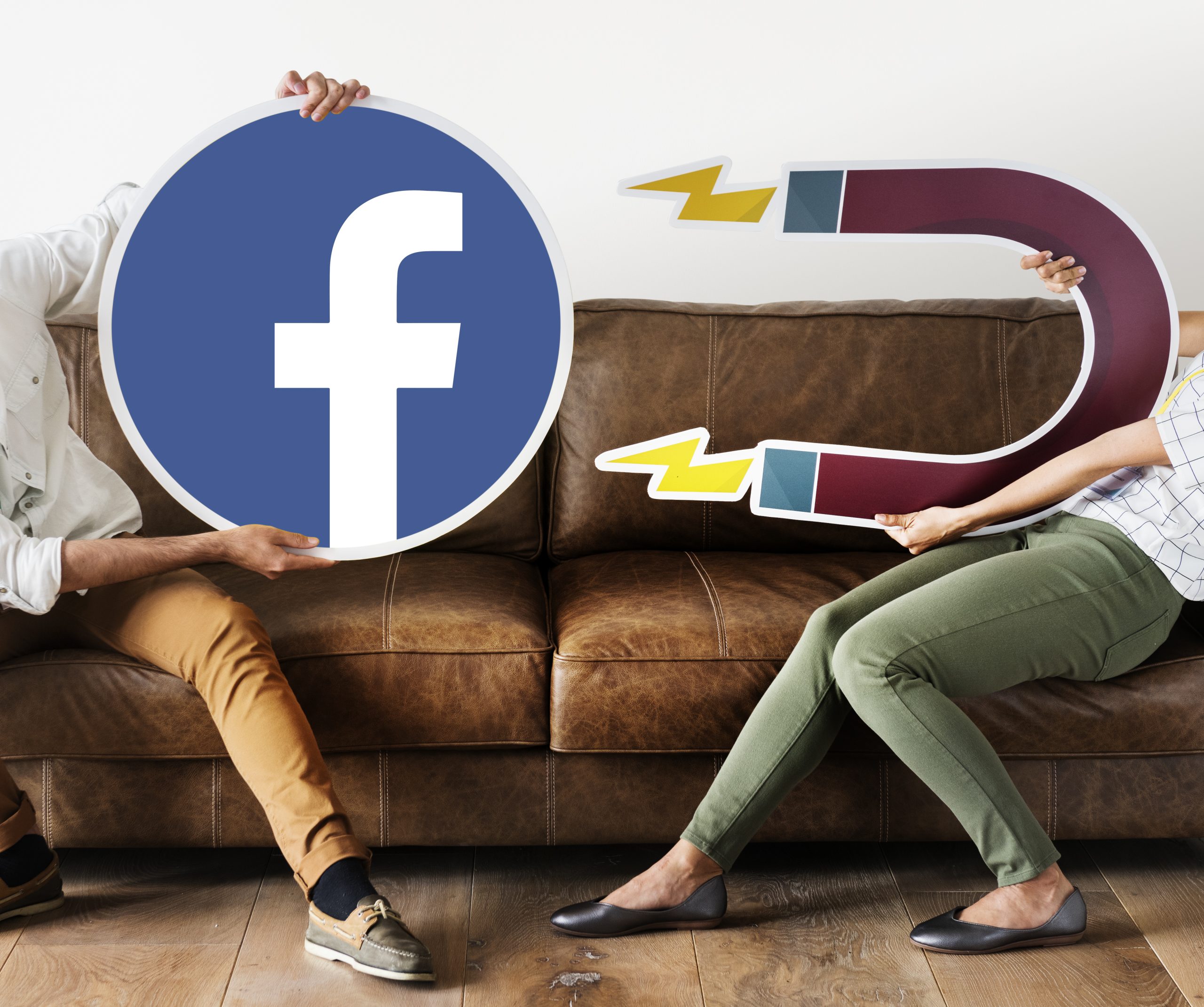 People holding a Facebook and magnet icons