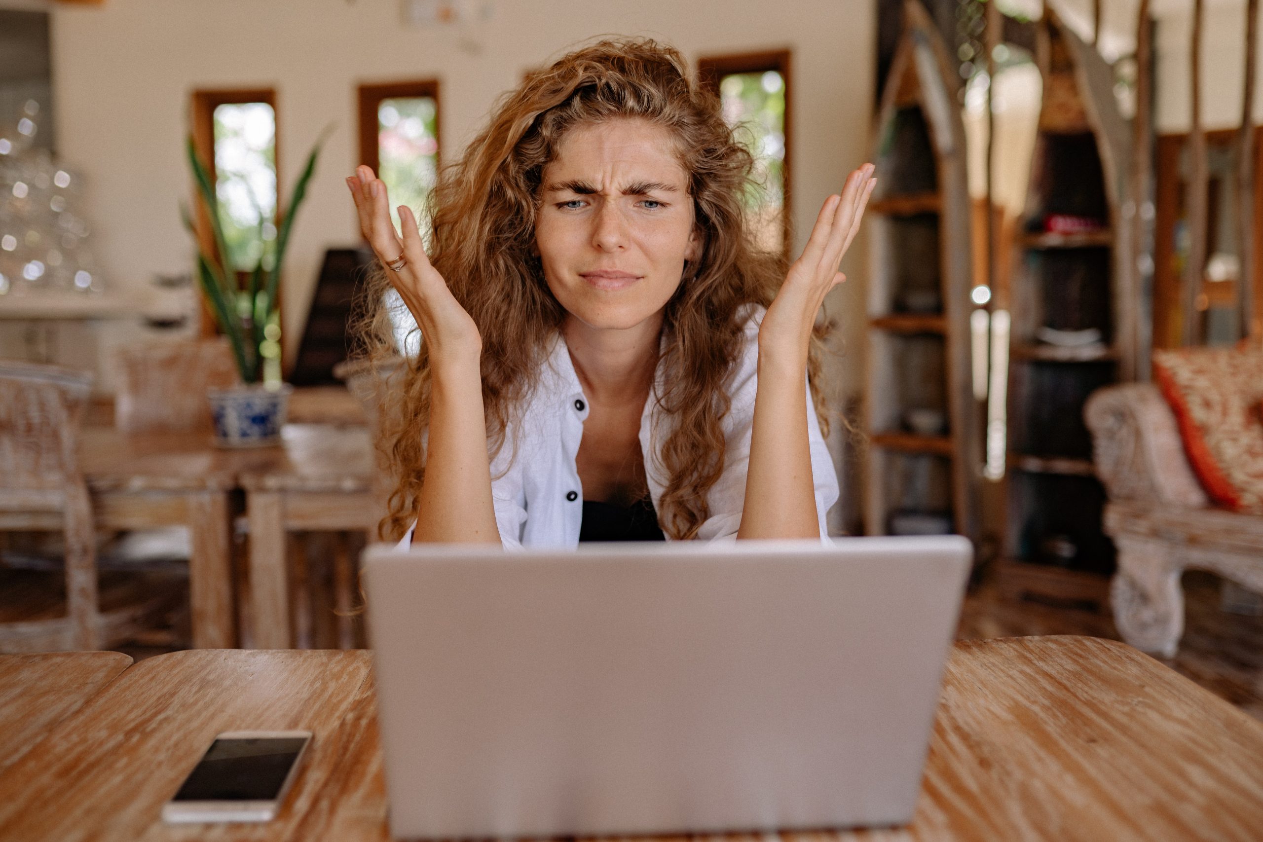 A puzzled woman, in front of her computer.