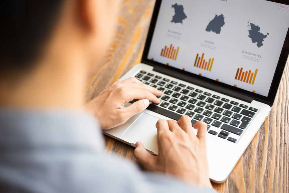 A business man looking at a report chart for improving B2C E-Commerce website performance.