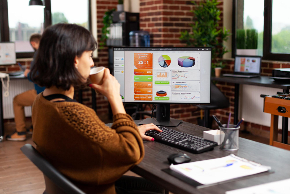 A digital marketer mastering the foundations of SEO while sipping a coffee in her office room.