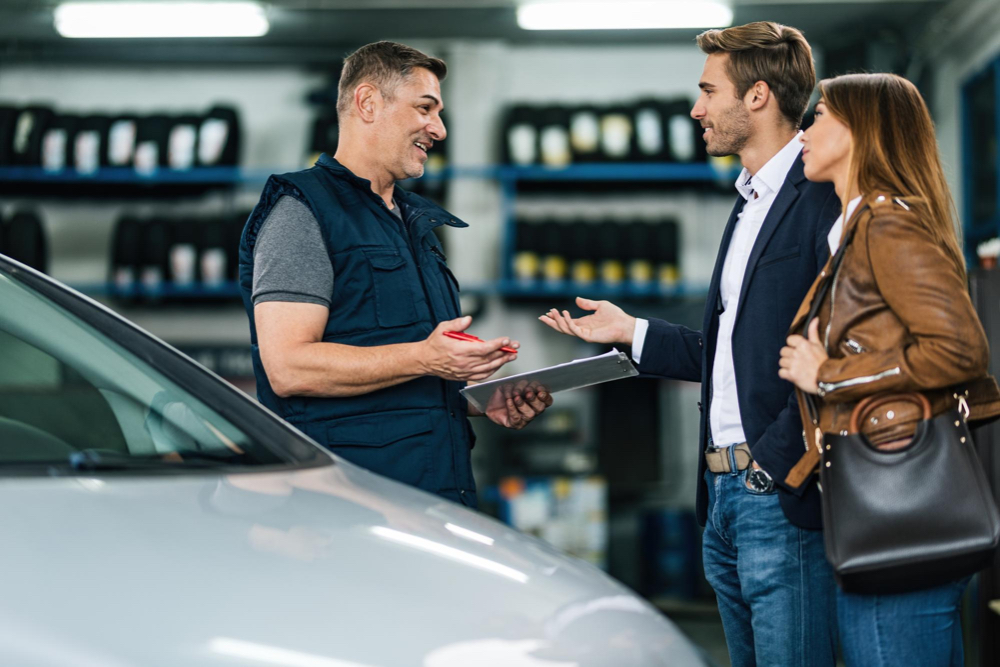 A small business owner handling customers inside a physical shop.