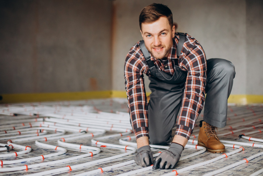 A man posing for a smile, while working on the installation of a pool heating service in Sydney.