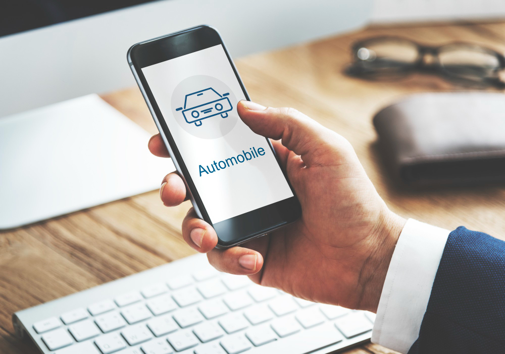 A hand checking on an automobile website, using a smartphone.