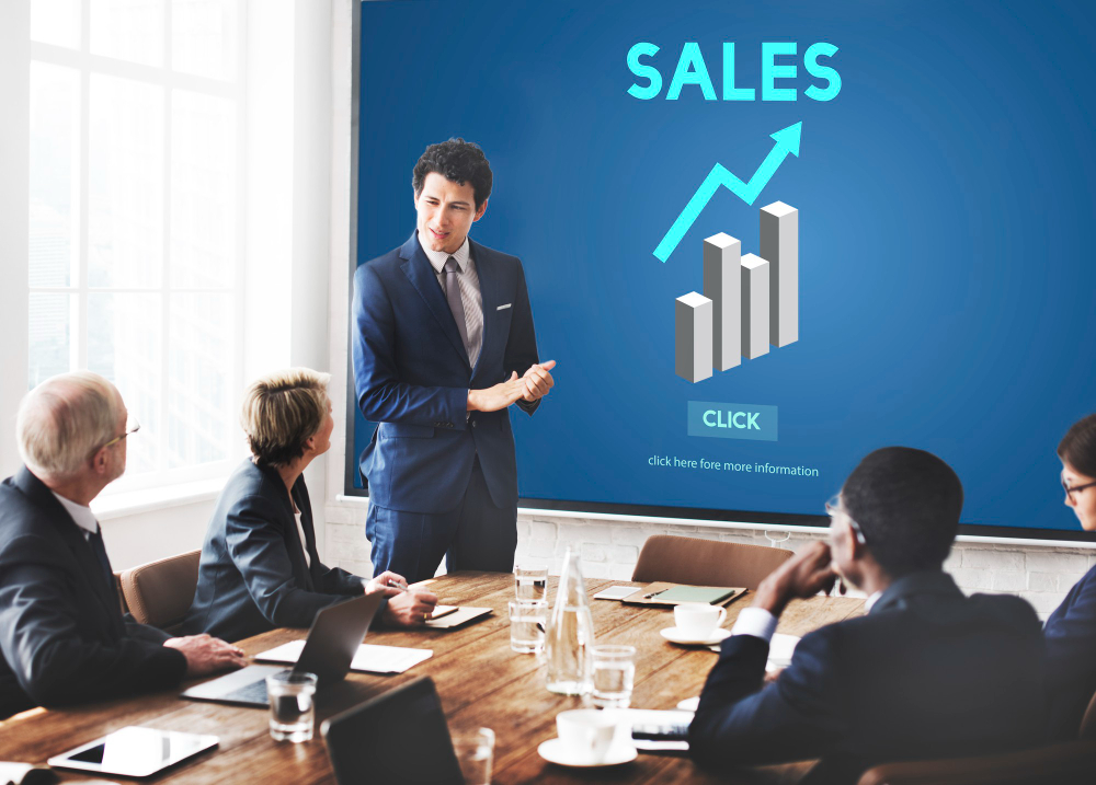 A group of E-Commerce businessmen, discussing about sales, inside a boardroom.